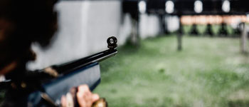 Firearm Range Services image showing somebody aiming a gun down a gun range
